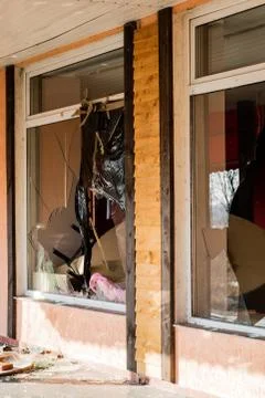 A broken window in an old abandoned building. Broken glass on the window site Fotos de archivo