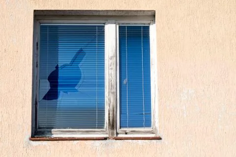 A broken window in an old abandoned building. Broken glass on the window site Fotos de archivo