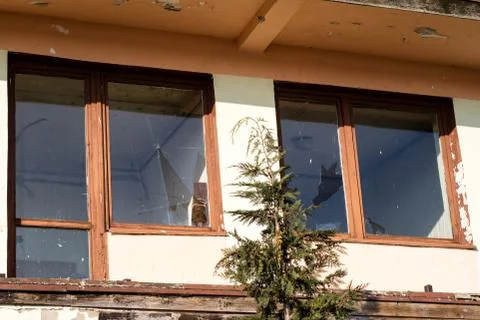 A broken window in an old abandoned building. Broken glass on the window site Fotos de archivo
