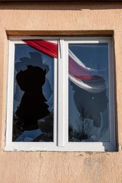 A broken window in an old abandoned building. Broken glass on the window site Fotos de archivo