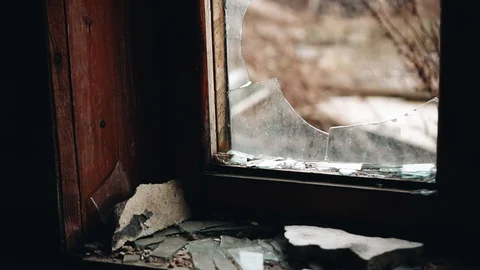 A broken window in an old broken house. Abandoned buildings. Post-Apocalypse Stock Footage 128016751