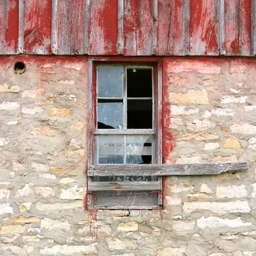 Broken window on old vintage barn Stock Photos