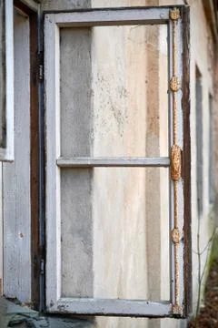 Broken window in old wall of abandoned house Stock Photos