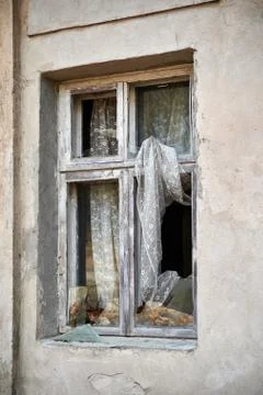 Broken window in old wall of abandoned house Stock Photos