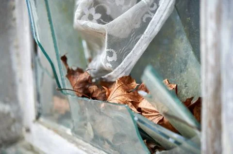 Broken window in old wall of abandoned house Stock Photos