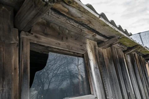 Broken window by an old wooden utility shed Stock Photos
