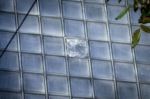 A broken window pane is visible on a building Fotos de archivo
