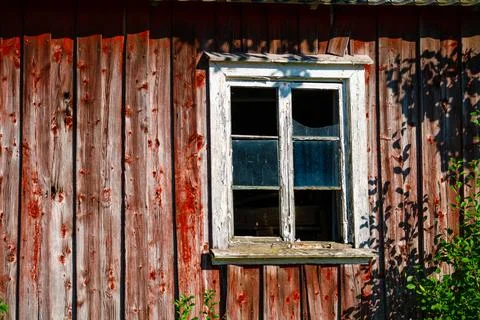 Broken window of a red barn Stock Photos