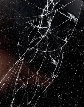 A broken window with a spider web pattern on it Foto stock