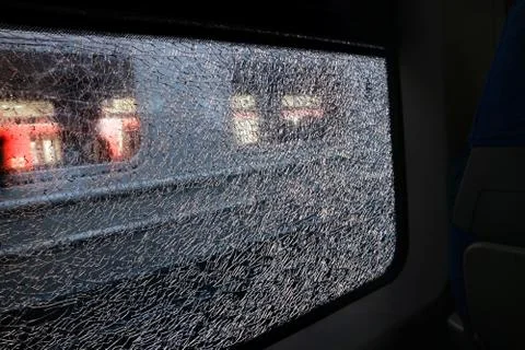 The broken window of the train is small pieces a network of cracks. Stock-Fotos