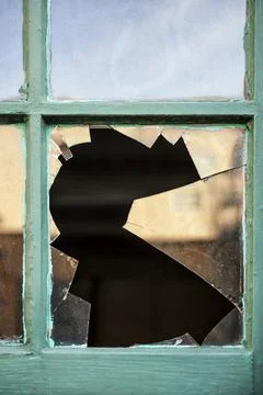 Broken Window,Closeup of broken glass in window pane Stock Photos