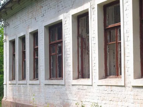 Broken windows in an abandoned house Stock Photos