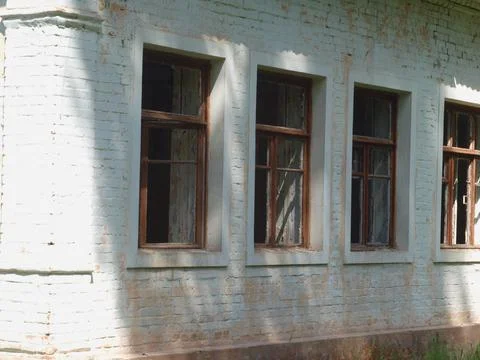Broken windows in an abandoned house. Stock Photos