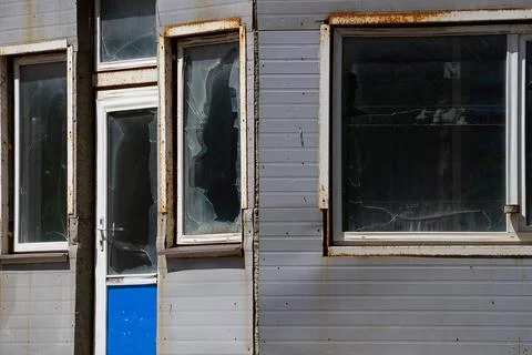 Broken windows in an abandoned store. Stock Photos