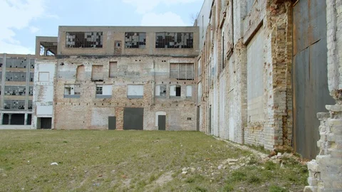 Broken windows and weathered brick walls of an old industrial building. 4k60p Stock Footage 130146699