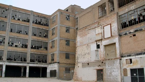 Broken windows and weathered brick of an old industrial building. 4k60p Video stock 130148993