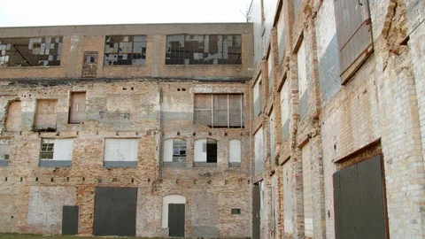Broken windows and weathered walls of an old industrial building. 4k60p Stock Footage 130149024