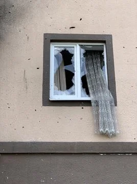 Broken windows by the blast wave from the explosion. Broken window in the hou Stock Photos