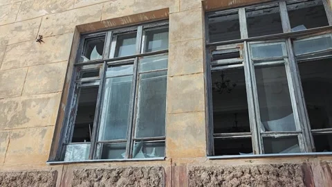 Broken windows in building after explosion damage Stock Footage 340030436