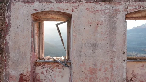 Broken windows, empty window frames and panes missing glass backlit by sun Stock Footage 232552955