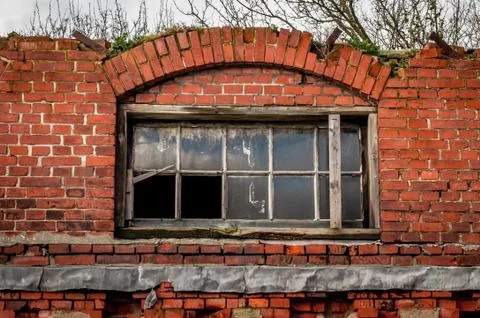 Broken windows in a old building with broken bricks Stock Photos
