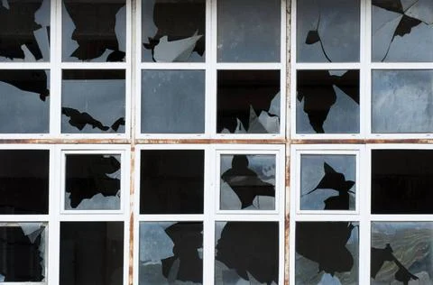 Broken windows of old building Broken windows of old building. White frame... Stock Photos