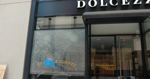 Broken windows at a vandalized store in Washington, DC Stock Footage 131490055