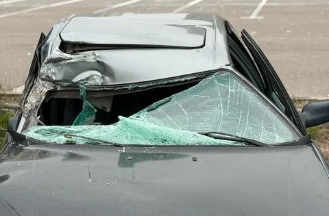 A broken windshield of a car as a result of a traffic accident. Stock Photos
