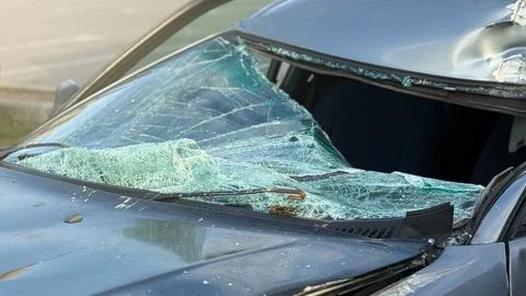 A broken windshield of a car as a result of a traffic accident. Stock Photos