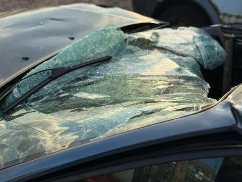 A broken windshield of a car as a result of a traffic accident. Stock Photos