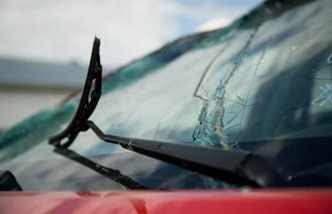 Broken windshield wiper on a broken car window Stock Photos