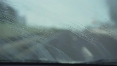 Broken wipers removing water drops from dirty windshield of car. Stock-Footage 155725060