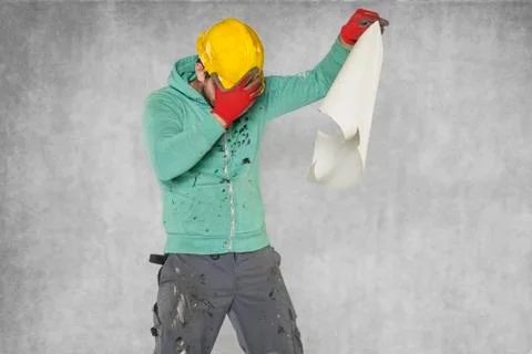 The broken worker reads the construction plans Stock Photos