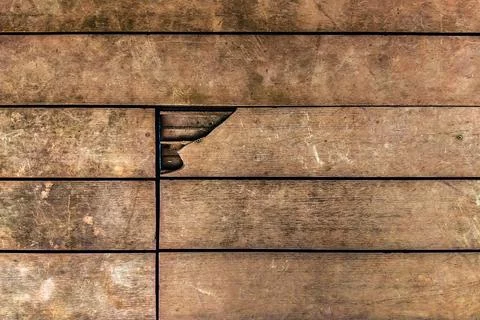 Broken WPC composite decking board on outdoor patio. Damaged hollow wood pl.. Stock Photos