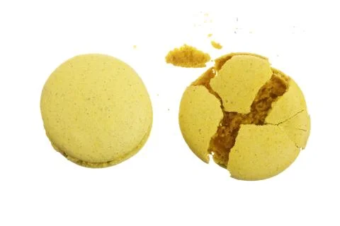 Broken yellow macarons isolated on white background closeup Fotos Stock