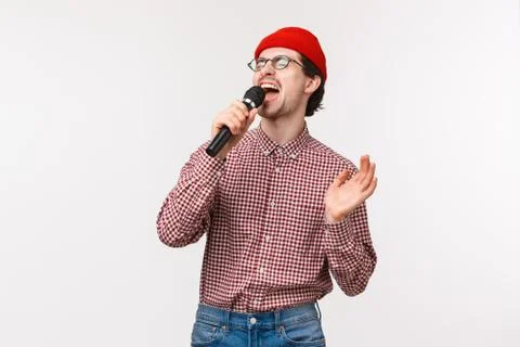 Brokenhearted guy singing romantic song in karaoke with passionate feeling Stock Photos