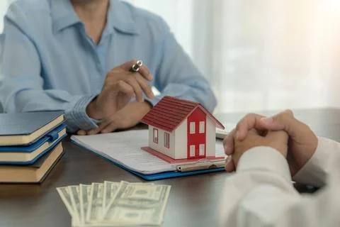 Broker advisor consulting a client. Real estate agent offer hand for customer Foto stock
