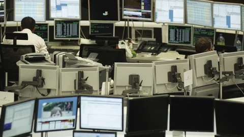 Broker in front of multi screen workspace - stock exchange - multitasking Stock Footage 70465933