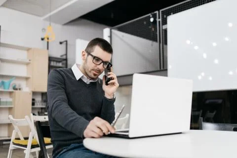 Broker talking on phone while working with computer Stock Photos