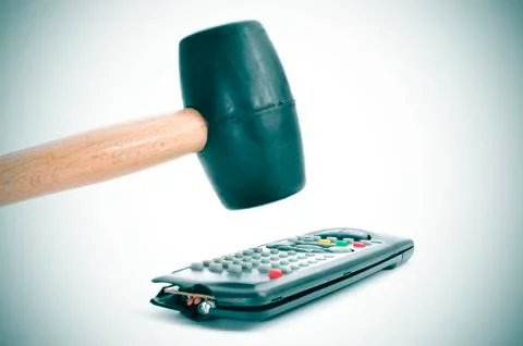 Broking a remote control with a hammer Stock Photos