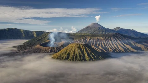 Bromo active volcano mountain with sea of fog in a morning sunrise Stock Footage 128164176
