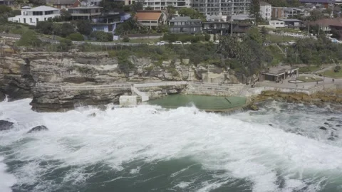 Bronte Baths | Scenic Waves | Circling Drone Shot | 4k HDR 스톡 동영상 207715897