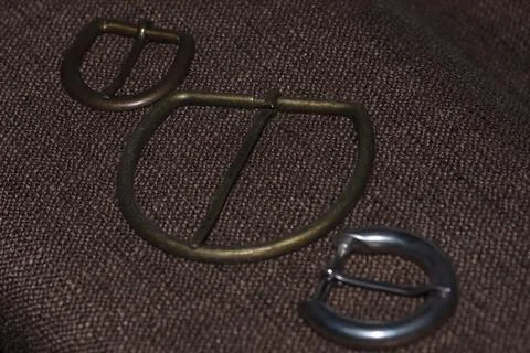 Bronze and silver decorative element for sewing,  metal buckle. Stock Photos