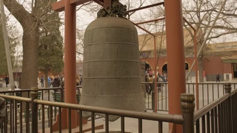 Bronze Bell in Lama Temple Courtyard with Visitors in Beijing, China Stock Footage 345683910