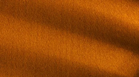 Bronze colored felt table surface with deep shadows Foto stock