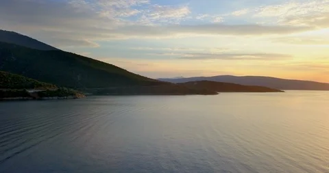 Bronze colored sunset on cloudy sky by the coastline Stock Footage 107959475