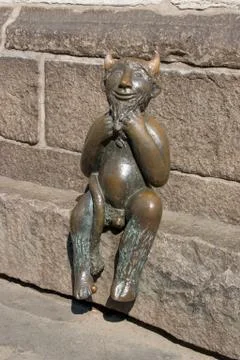 Bronze devil sitting Stock Photos