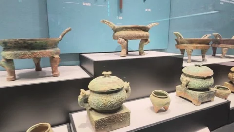 Bronze Ding and Pan Rows on Stepped White Platforms Stock-Footage 348069606