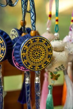 Bronze drum sun pattern embroidered round pendant on dark blue background Stock Photos