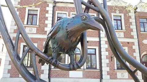 The bronze figure of a raven is set on the street of the Latvian city of Liep Stock Photos